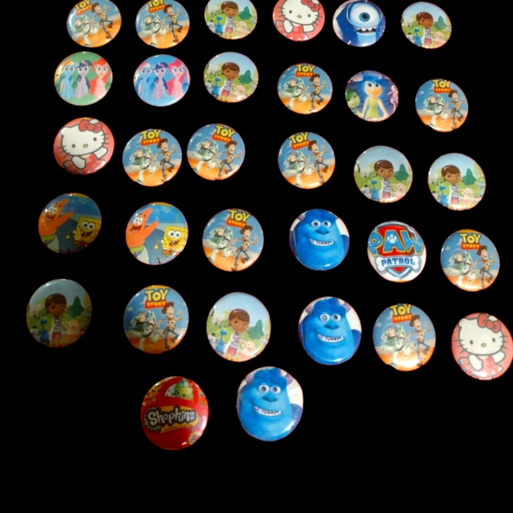 Thirty-two Cartoon Themed One Inch Buttons